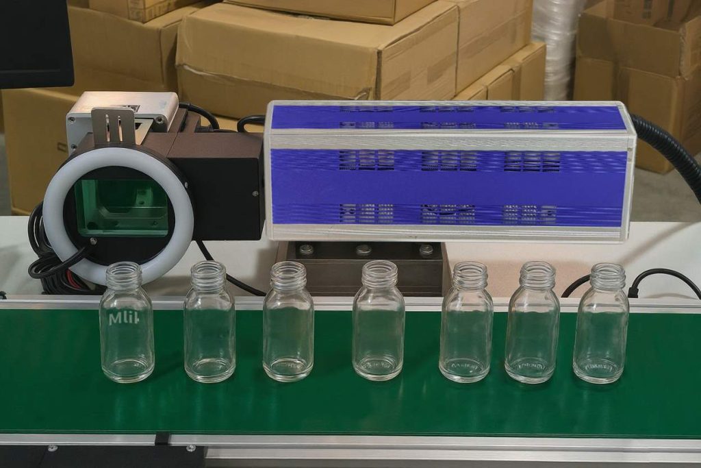 Flying CO2 laser marking on glass bottles