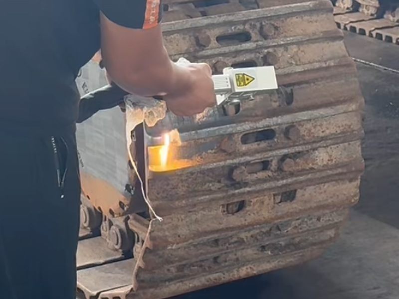 CW fiber laser cleaning process removing rust and paint from metal surface