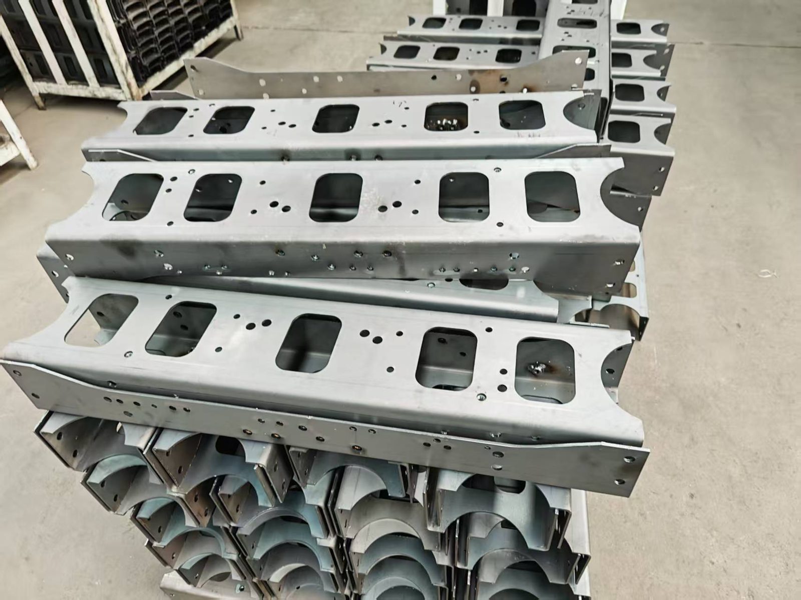 Batch of stamped automotive chassis brackets prepared for traceability marking