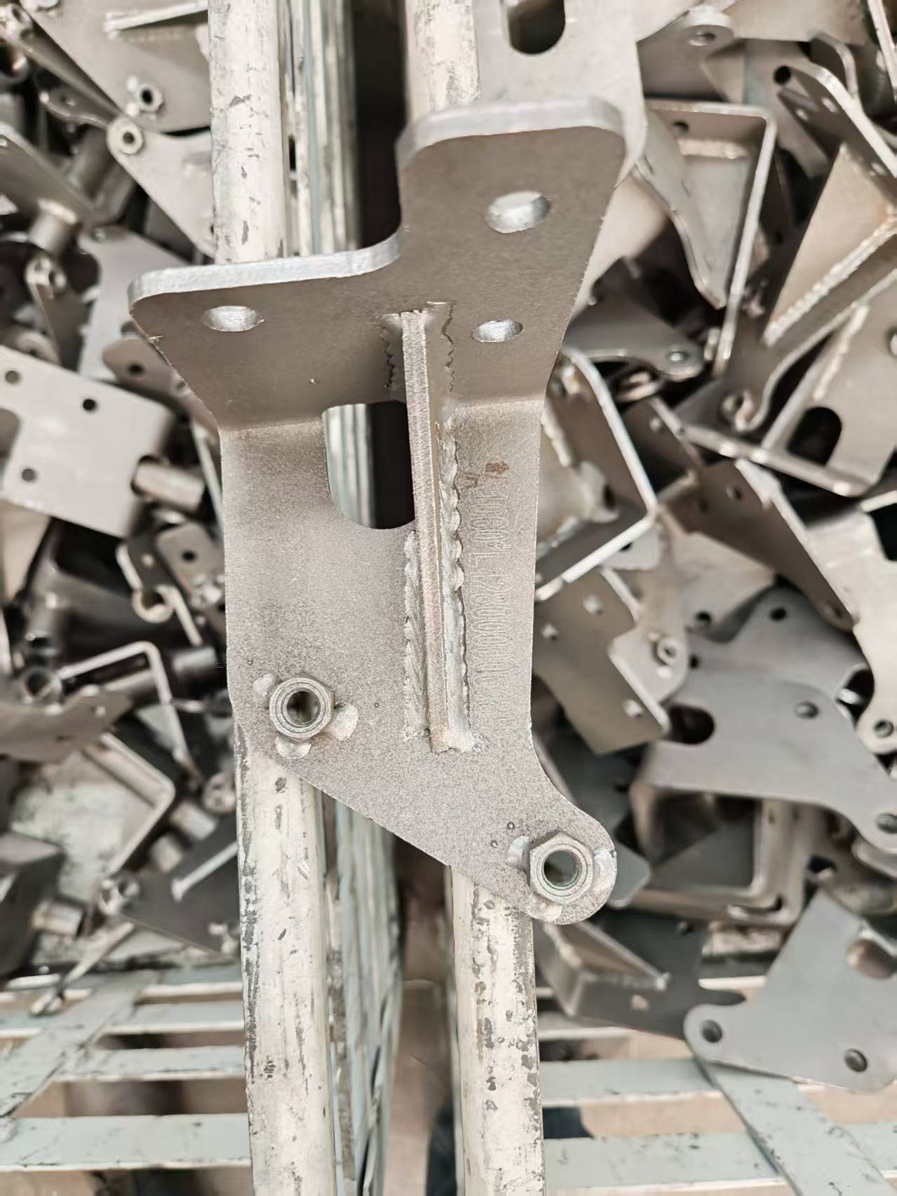 Machined automotive chassis link plate prepared for deep dot peen identification