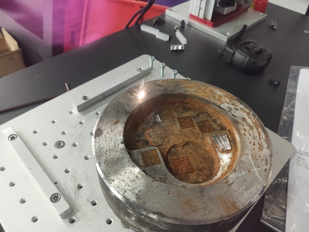 Close-up of relief serial numbers deep engraved on a die casting mold during Zixu 3D laser sampling