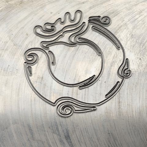 Decorative outline dot peen mark on metal part