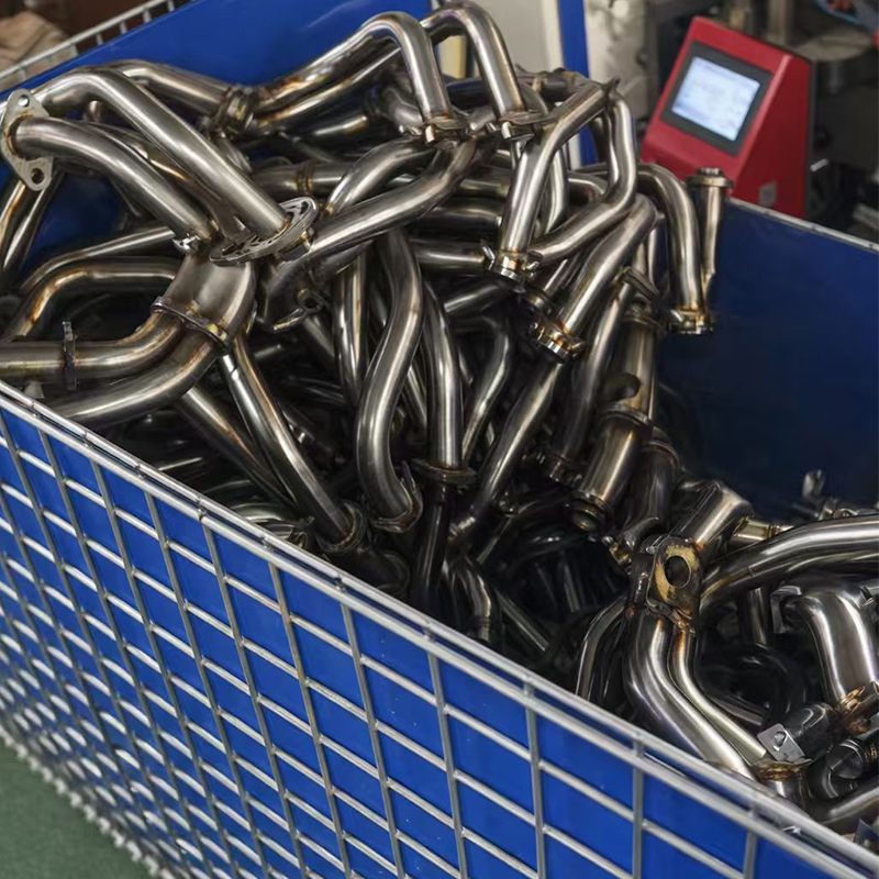 Motorcycle exhaust pipe headers showing clean welded seams after handheld laser welding at Jinmao Machinery