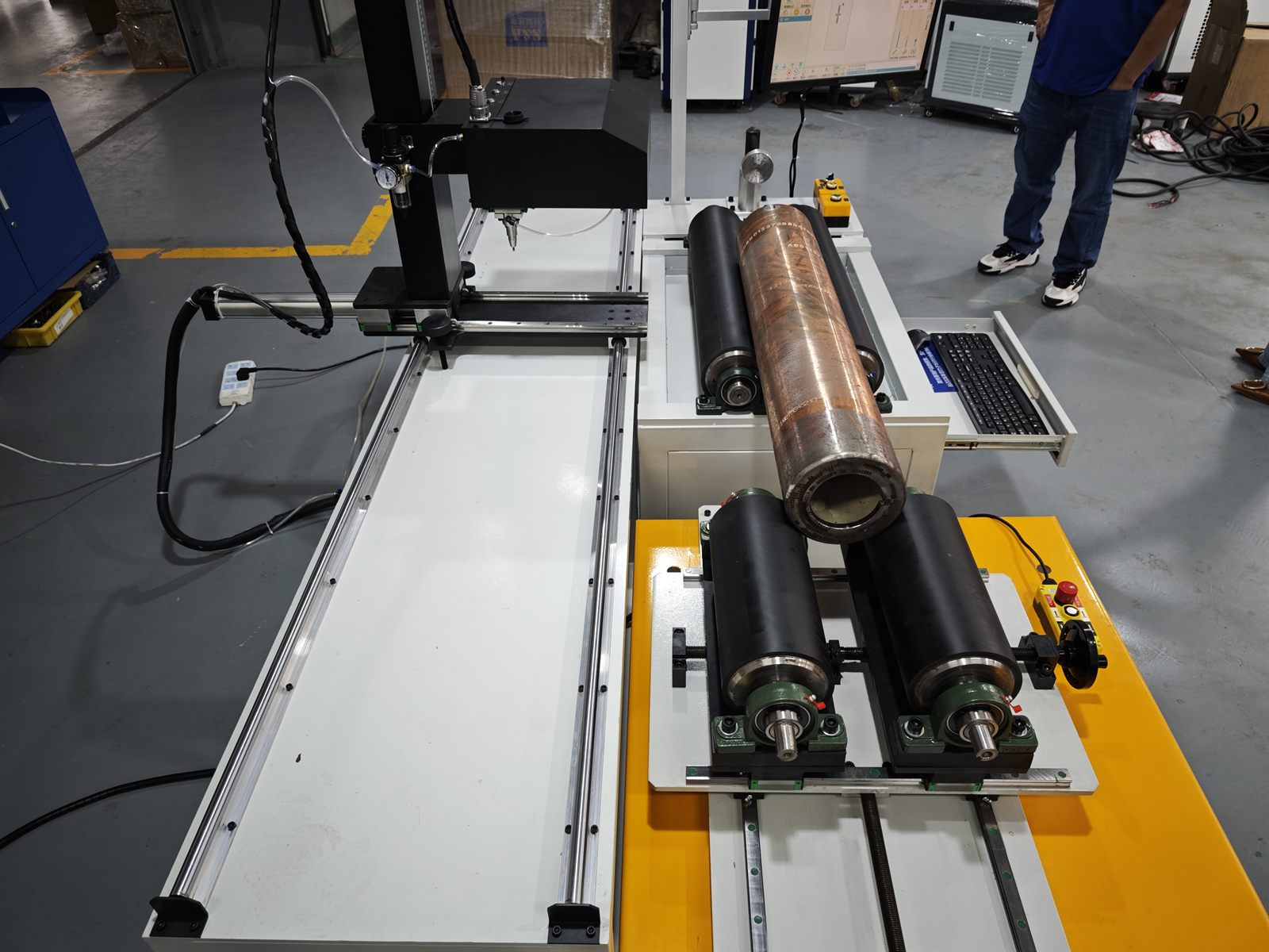 Diamond dot peen marking head positioned above a supported drill pipe workpiece