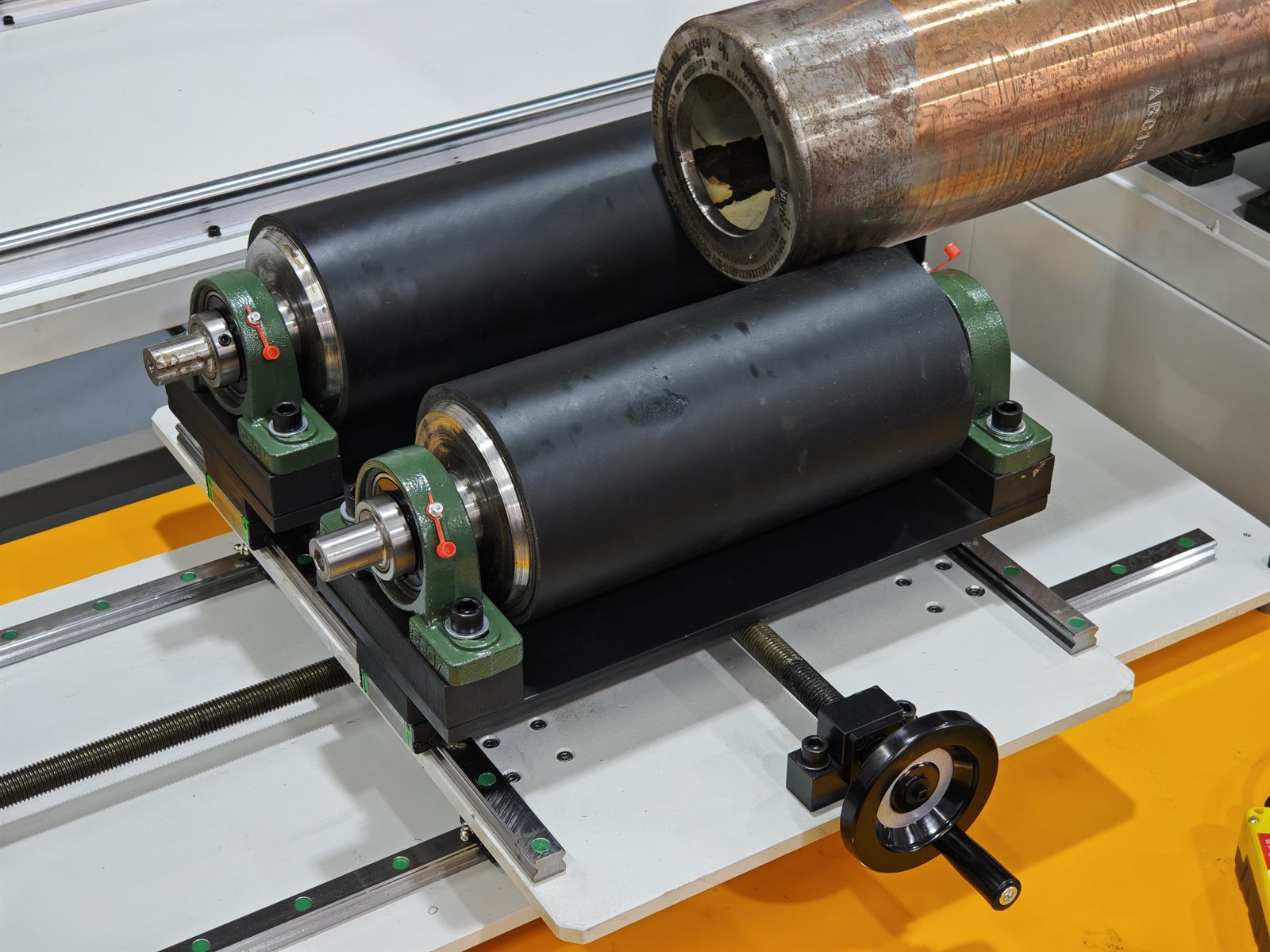 Split roller support keeps the heavy cylindrical workpiece level during marking
