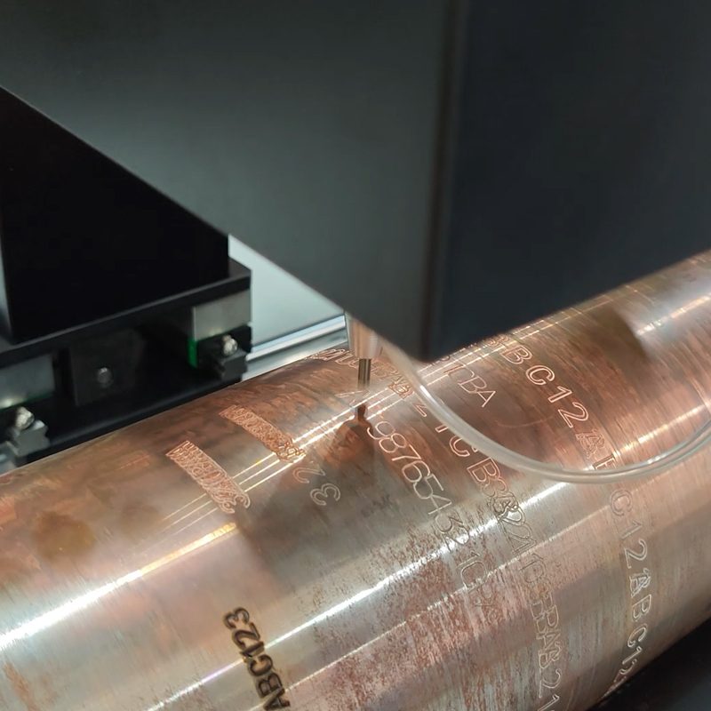 Close-up of permanent dot peen identification marked on an oil drilling rod surface