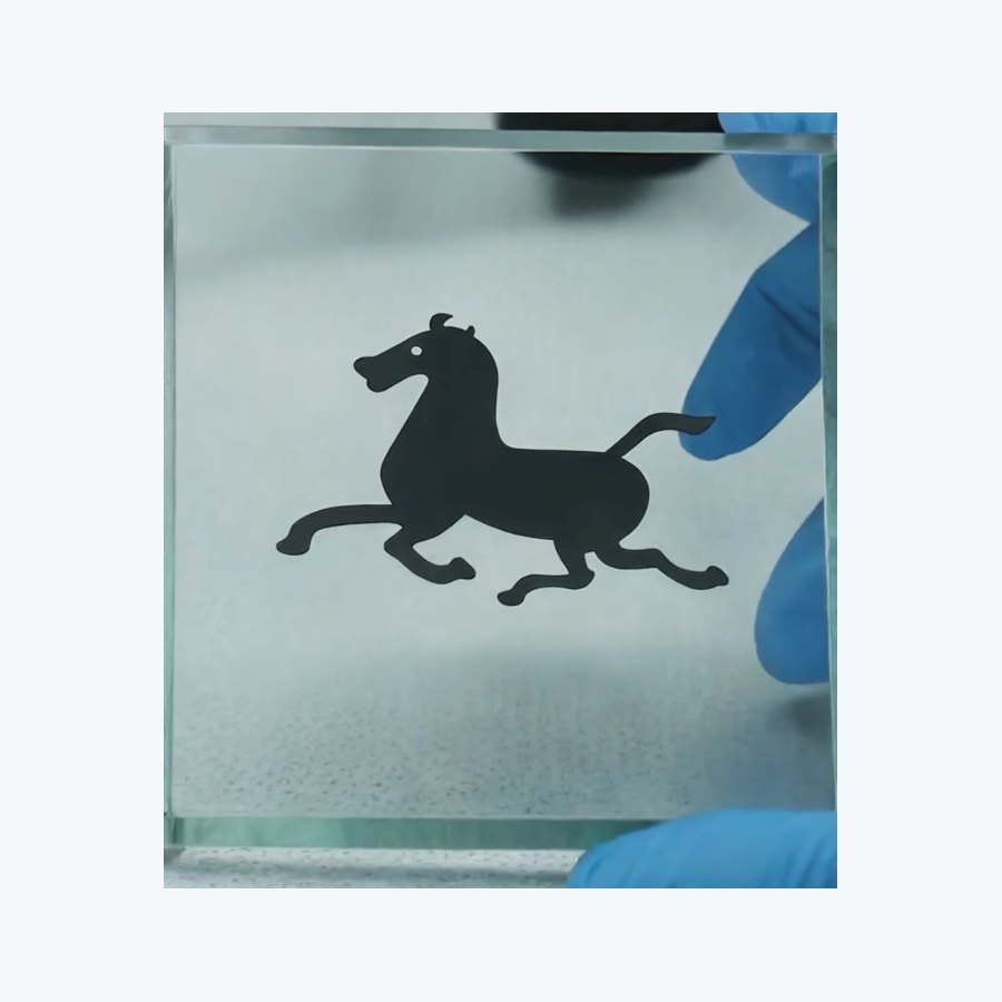 Front view detail of pure black marking on glass made by picosecond laser processing