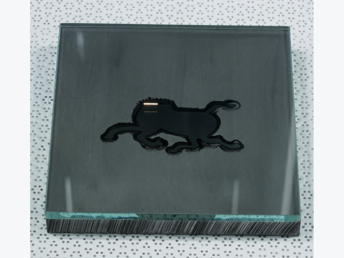 Glass black marking process sample showing target-assisted picosecond laser marking result