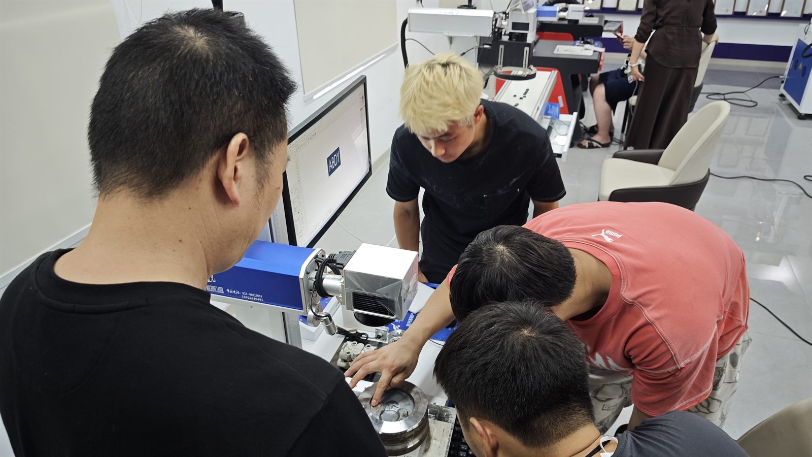 Customer and ZiXu engineers reviewing the laser deep engraving position on an automotive mold