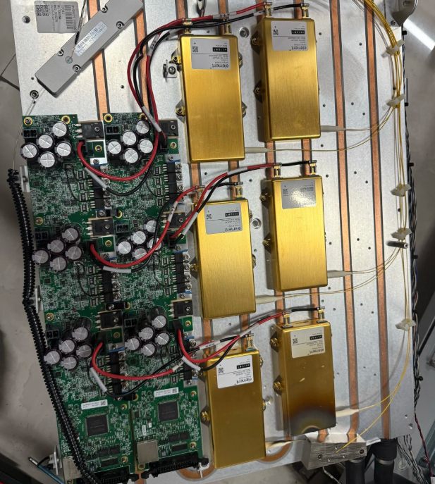 Internal electrical and optical components of an industrial laser source during maintenance inspection