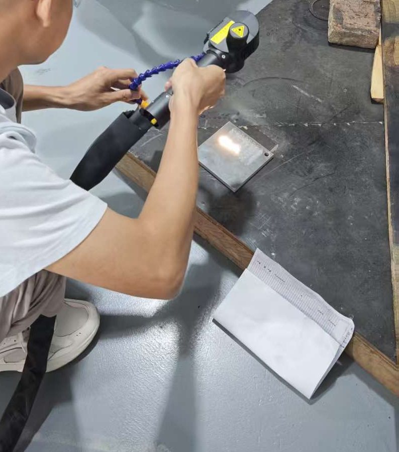Customer reviewing pulsed laser cleaning sample process for selective coating removal