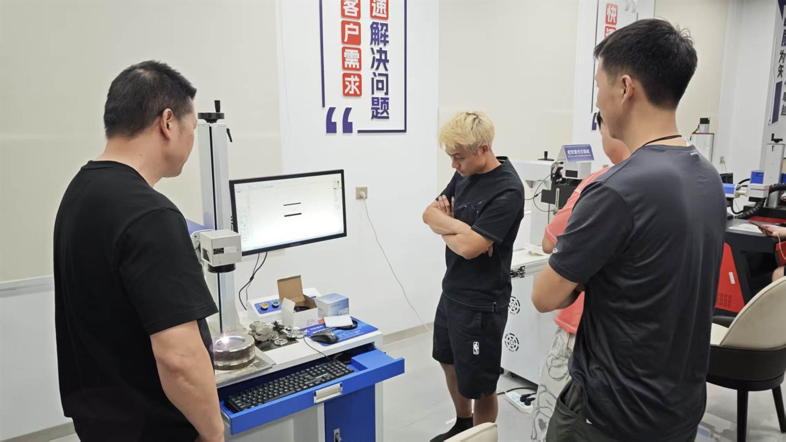 ZiXu team discussing the 100W MOPA automotive mold deep engraving test result with the customer