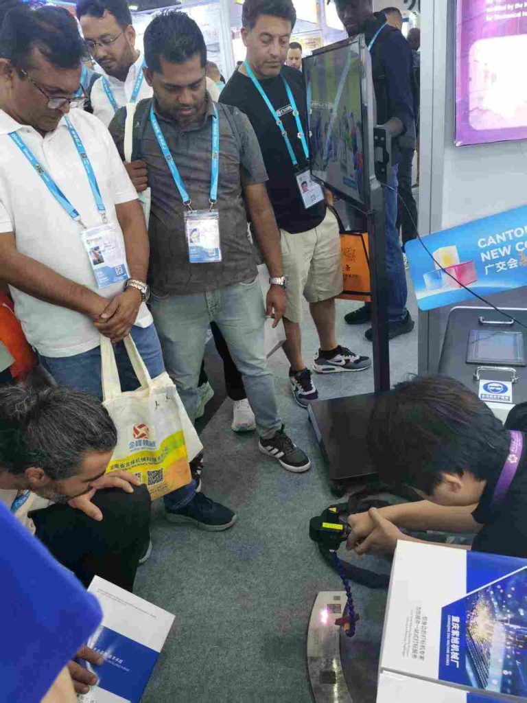 Buyers crowd around the cleaning gun during the live demo